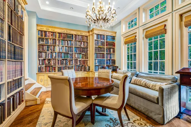 a living room with furniture and a chandelier