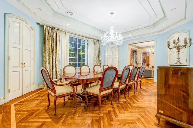 a kitchen with stainless steel appliances granite countertop a stove a sink dishwasher a refrigerator and a fireplace with wooden floor