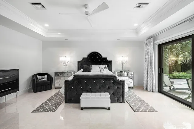 a bedroom with a bed and a flat tv screen on wall