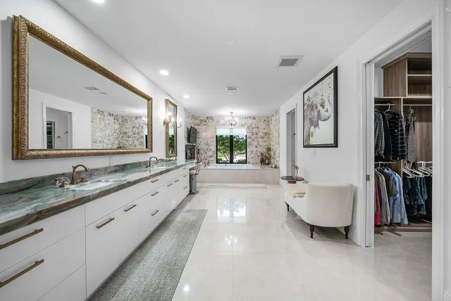a bathroom with a sink and a large mirror