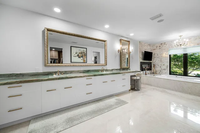 a living room with furniture and a painting on the wall