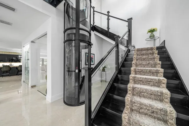 a bedroom with a bed and glass window