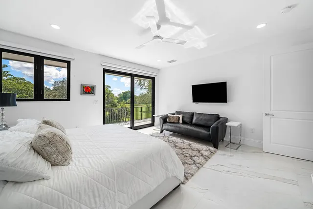a view of a house with swimming pool and sitting area