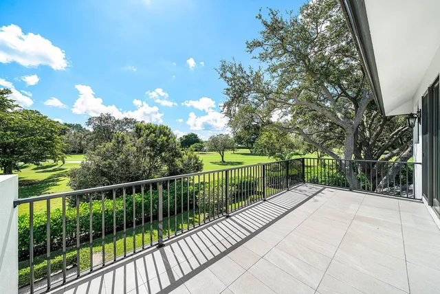 an aerial view of a house with swimming pool and garden space