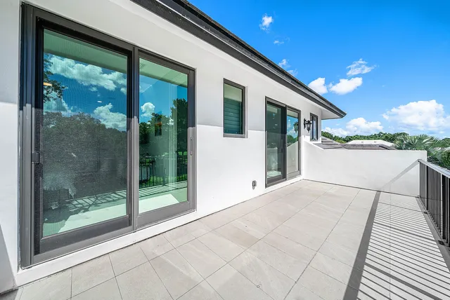 an aerial view of a house with swimming pool garden and patio