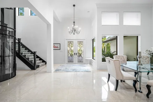 a living room with furniture a flat screen tv and a large window
