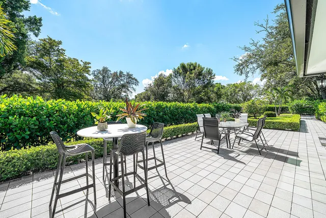 a view of a chairs and table in patio