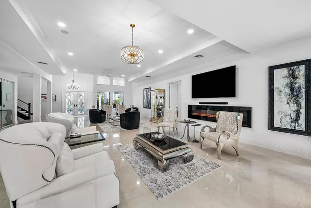 a living room with furniture and a floor to ceiling window