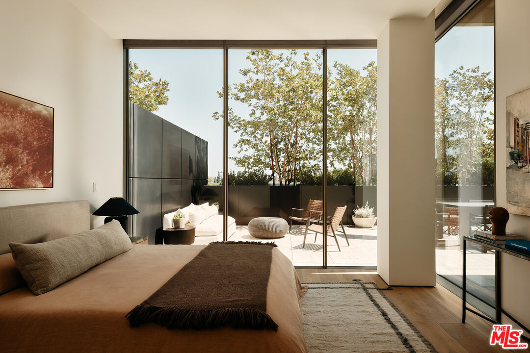 8899 Beverly Boulevard, Unit 4D Los Angeles, CA 90048 - Photo 11 of 28 a bedroom with furniture and a large window