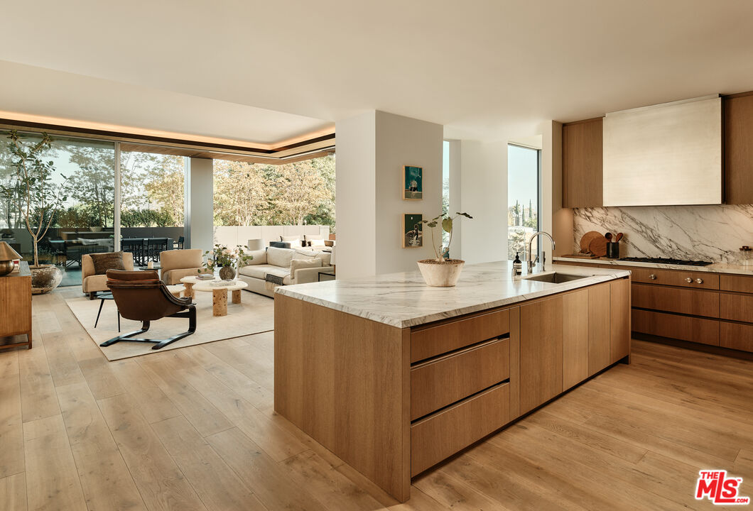 8899 Beverly Boulevard, Unit 4D Los Angeles, CA 90048 - Photo 3 of 28 a living room with stainless steel appliances granite countertop couches a coffee table and chairs in it