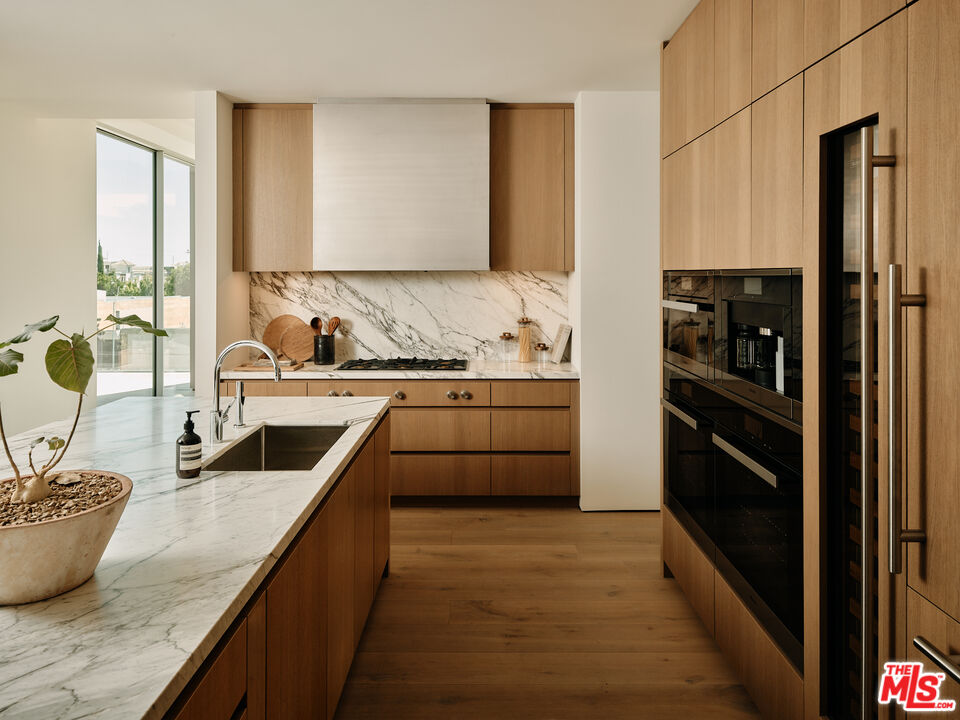 8899 Beverly Boulevard, Unit 4D Los Angeles, CA 90048 - Photo 5 of 28 a kitchen with counter top space and stainless steel appliances