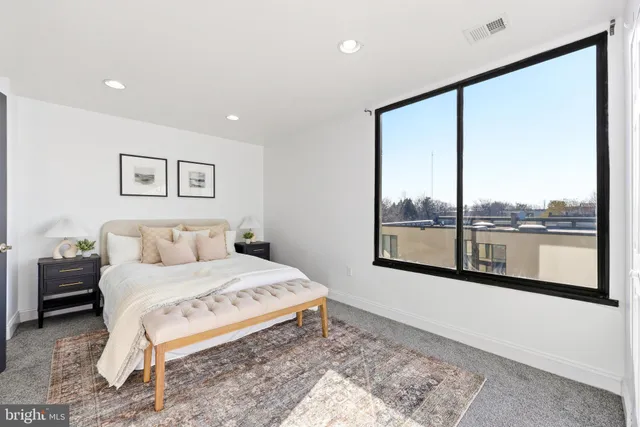 a view of a bedroom with a bed and glass door