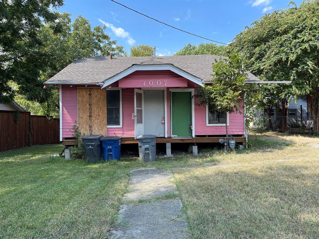 a view of a house with a yard and sitting area