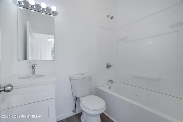 a bath room with a toilet a sink and a bath tub