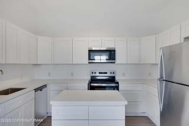 a kitchen with a refrigerator and a sink