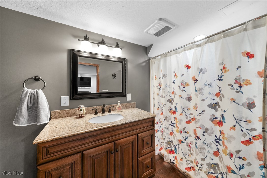 110 Judson Road Kent, OH 44240 - Photo 21 of 35 Bathroom with hardwood / wood-style floors, vanity, and a shower with shower curtain