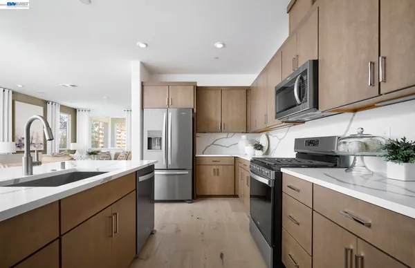 a kitchen with a sink stove and refrigerator