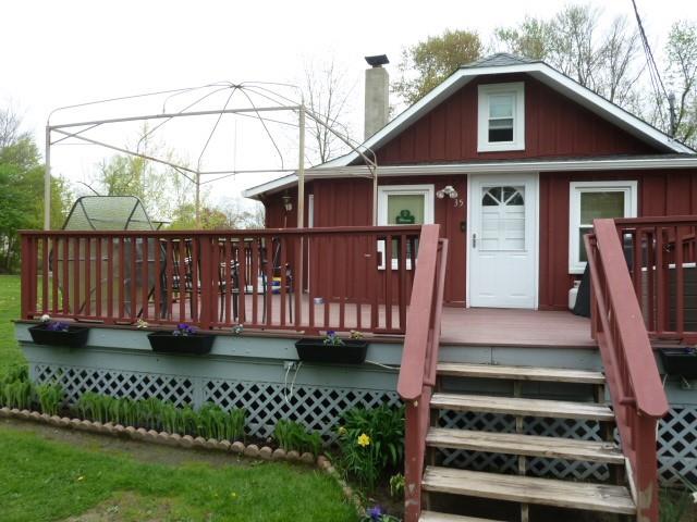 a view of a house with a small yard and wooden fence