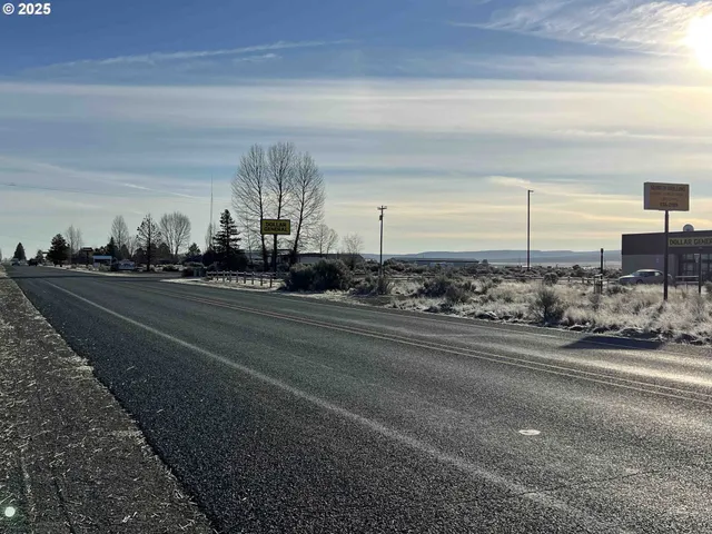a view of a street with cars on road