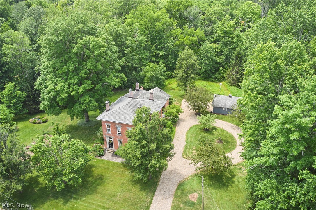 5046 Alger Road Richfield, OH 44286 - Photo 3 of 49 Expansive property featuring a brick residence with a gabled roof, a separate accessory structure, and a circular driveway