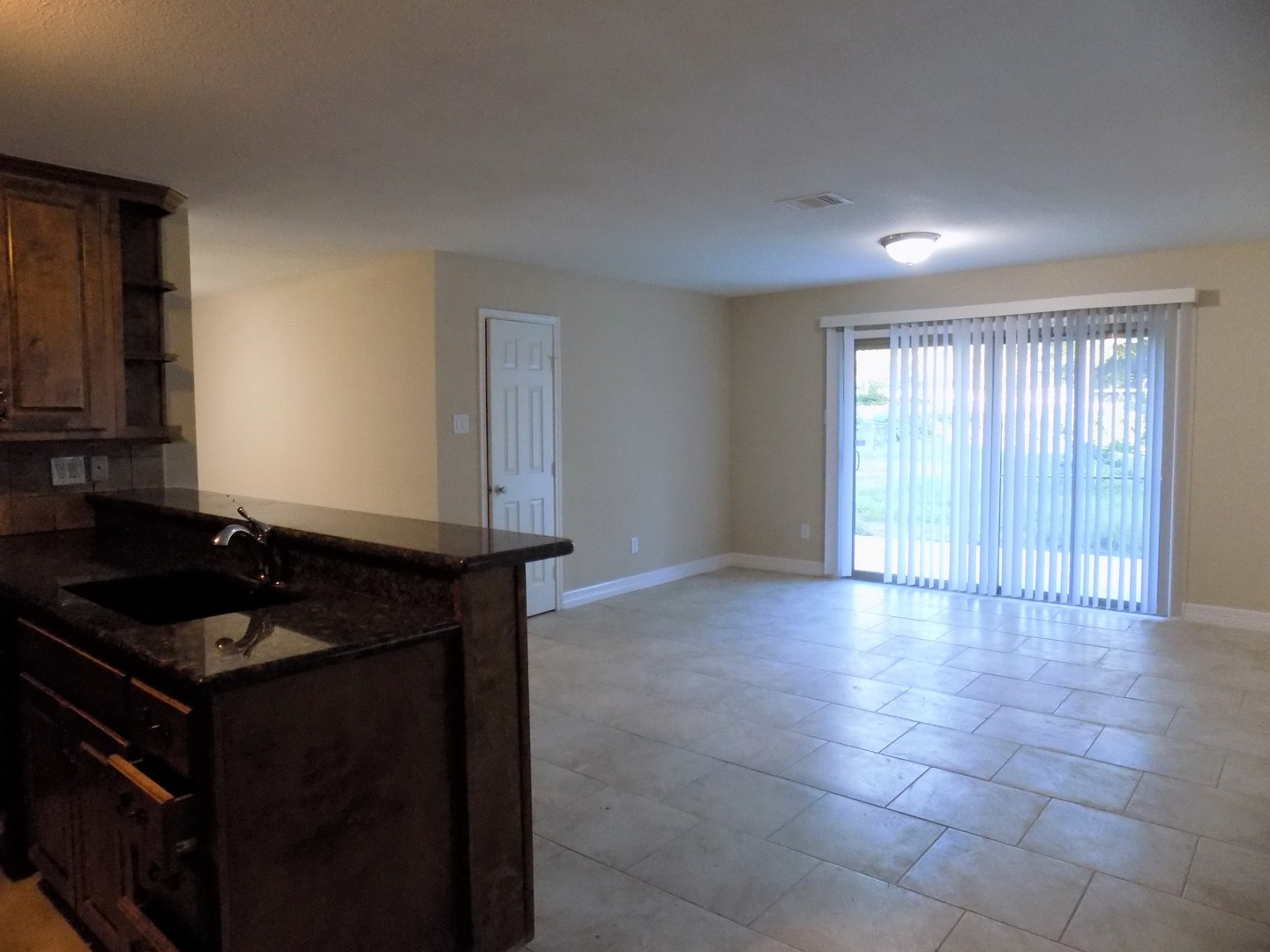 12705 Pebble Creek Lane Cypress, TX 77429 - Photo 5 of 19 a kitchen with granite countertop a stove a sink and a window