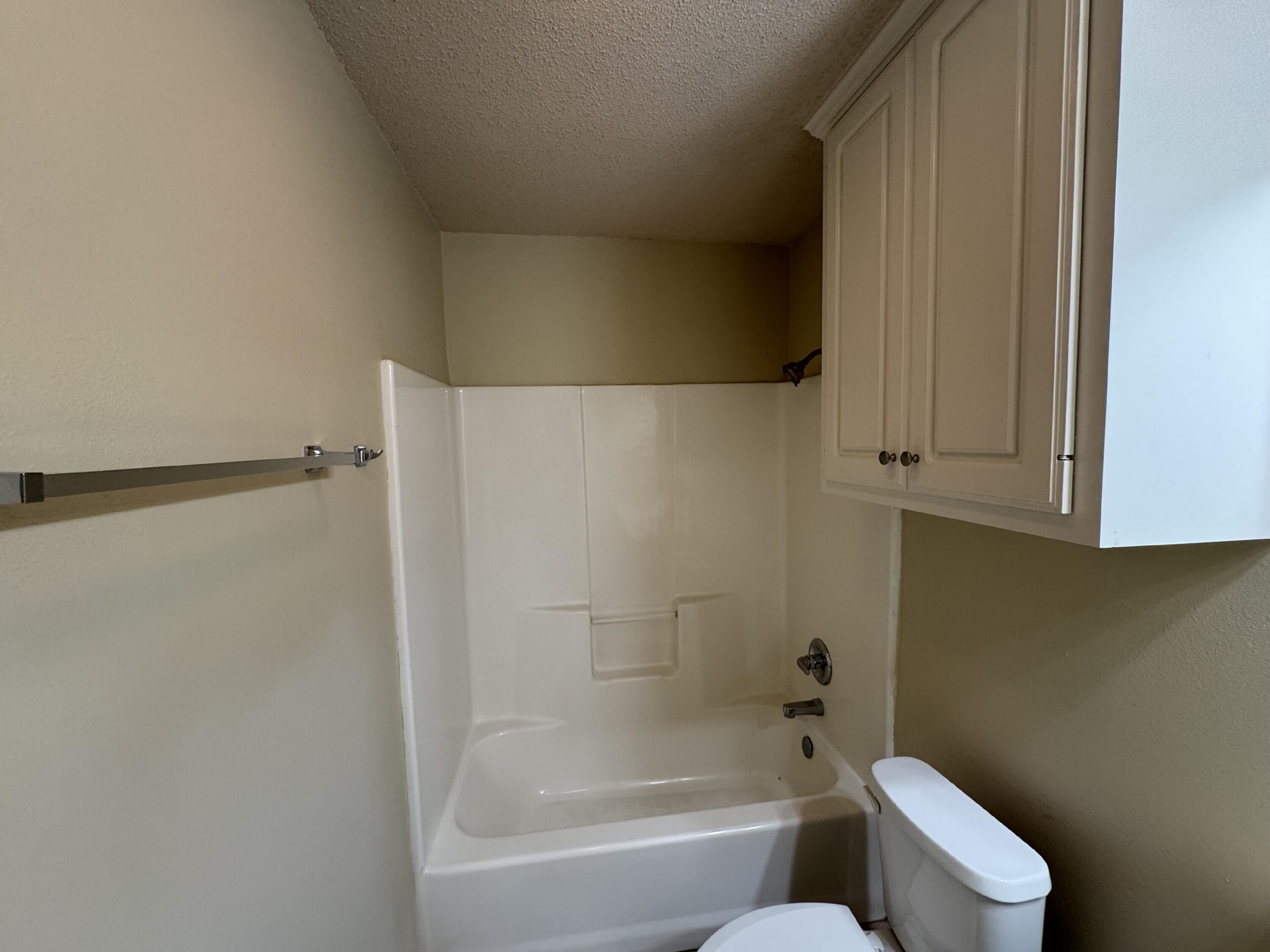 511 North Clinton Avenue, Unit A Lubbock, TX 79416 - Photo 15 of 15 a bathroom with a toilet and a bathtub