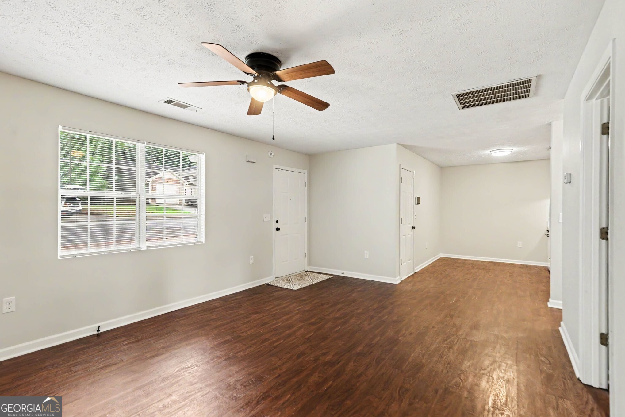 209 East Wilson Street Villa Rica, GA 30180 - Photo 5 of 24 SPACIOUS FAMILY ROOM THAT IS OPEN TO THE KITCHEN WITH LAMINATE FLOORING.