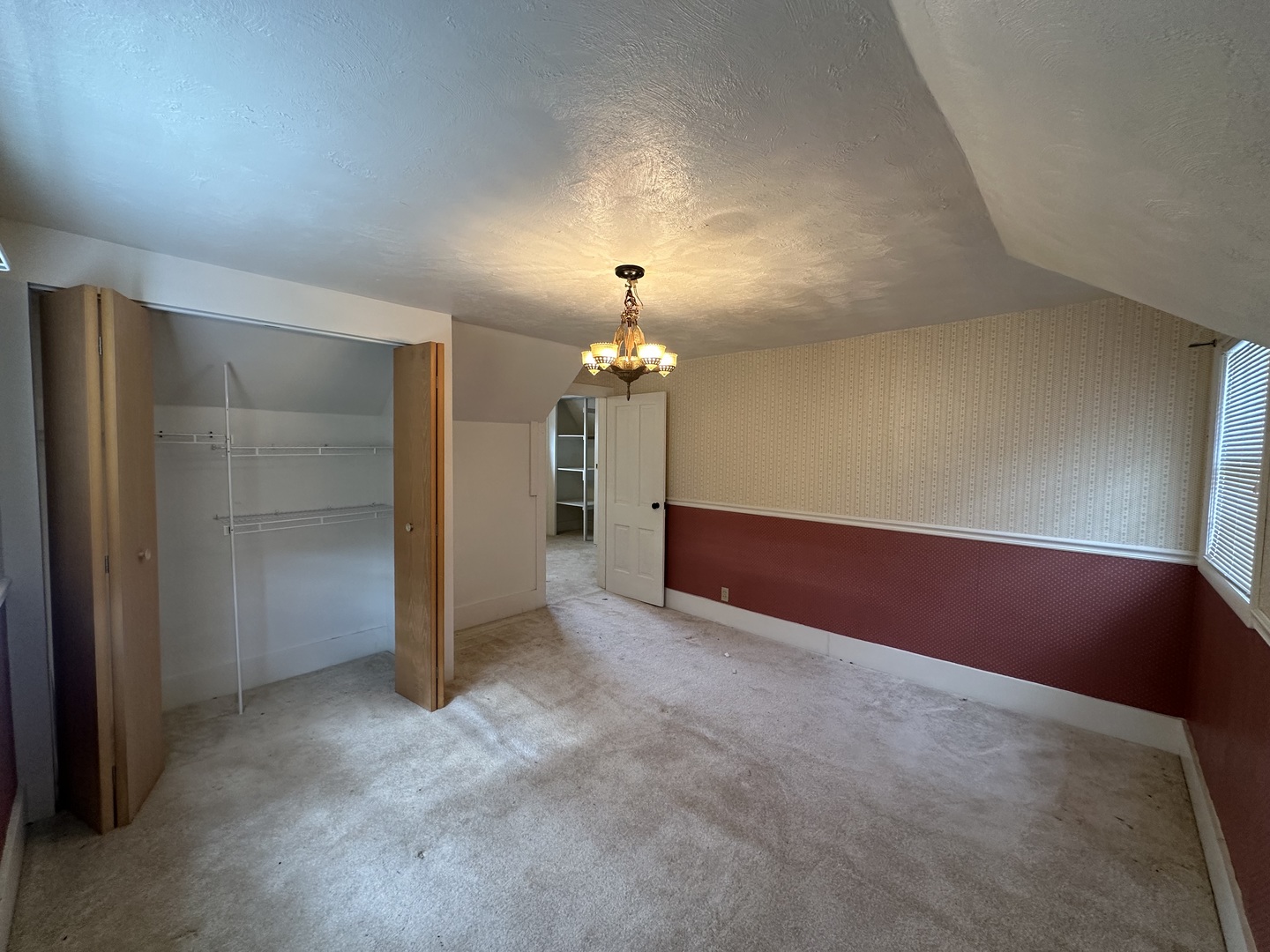 10015 Stichter Street Fenton, IL 61251 - Photo 26 of 35 an empty room with closet and a chandelier fan