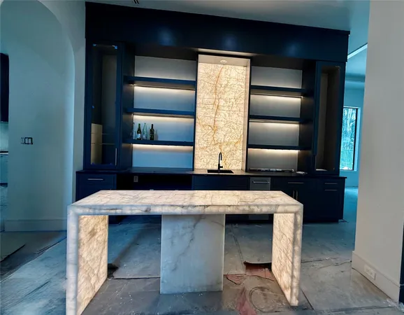 a kitchen with kitchen island and stainless steel appliances
