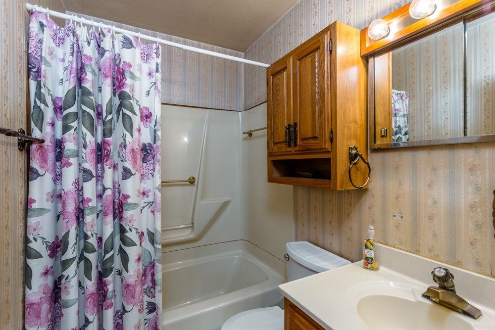 10807 Indian Trail Road Harrisonburg, VA 22802 - Photo 14 of 32 a bathroom with a sink and a mirror