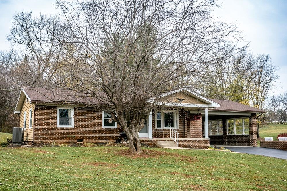 10807 Indian Trail Road Harrisonburg, VA 22802 - Photo 19 of 32 a front view of a house with a garden and trees