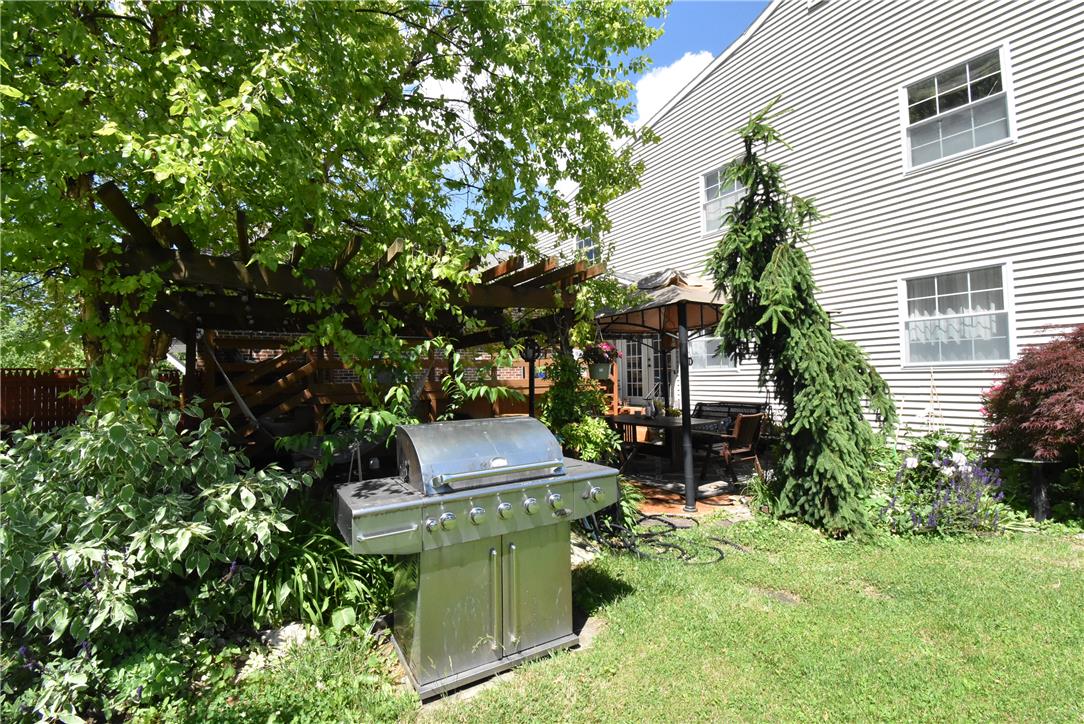 424 Grape Street Whitehall, PA 18052 - Photo 45 of 50 A verdant backyard retreat with a covered patio area for outdoor dining and entertaining.