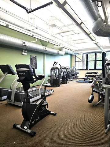 a gym room with lots of gym equipment
