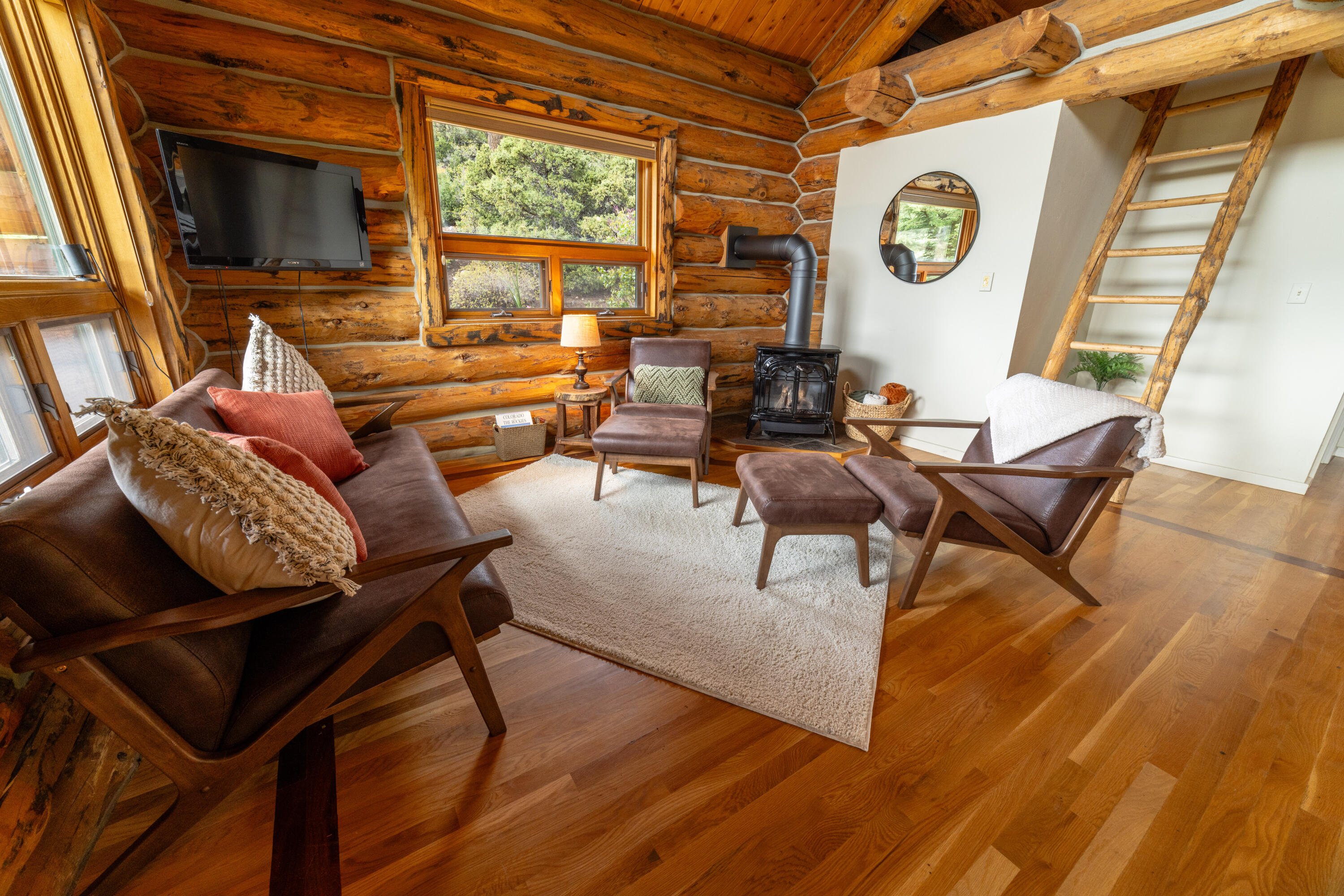 2001 County Road Placerville, CO 81430 - Photo 15 of 37 a living room with couches a flat screen tv and a large window with wooden floor