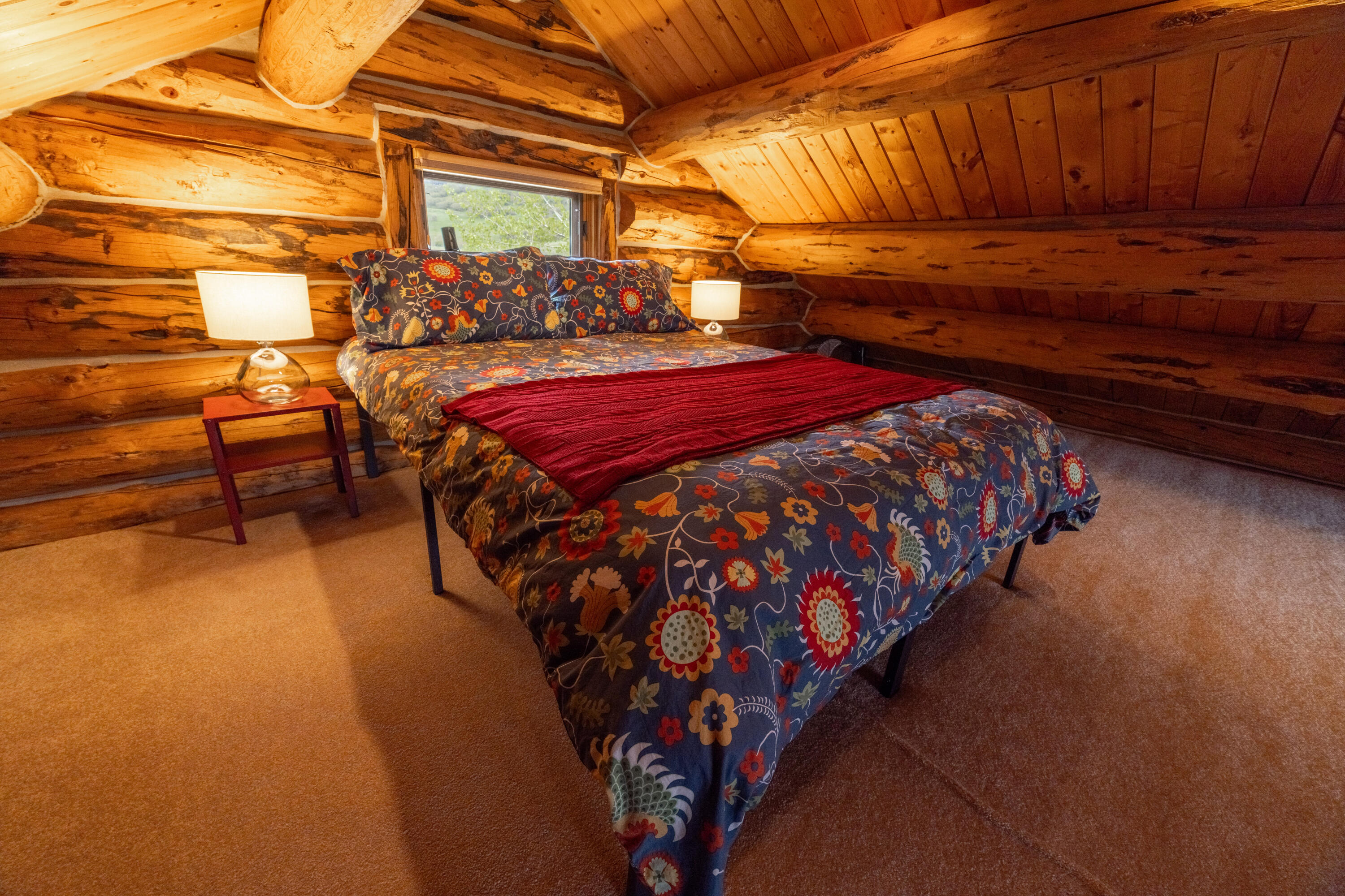 2001 County Road Placerville, CO 81430 - Photo 25 of 37 a bed sitting in a room next to a chair