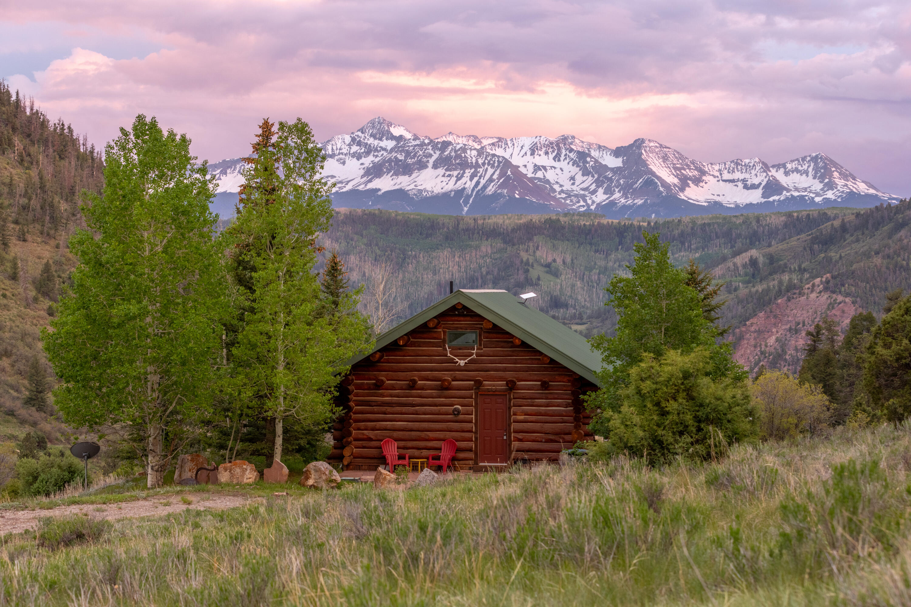 2001 County Road Placerville, CO 81430 - Photo 4 of 37 a view of a house with a small yard and large trees