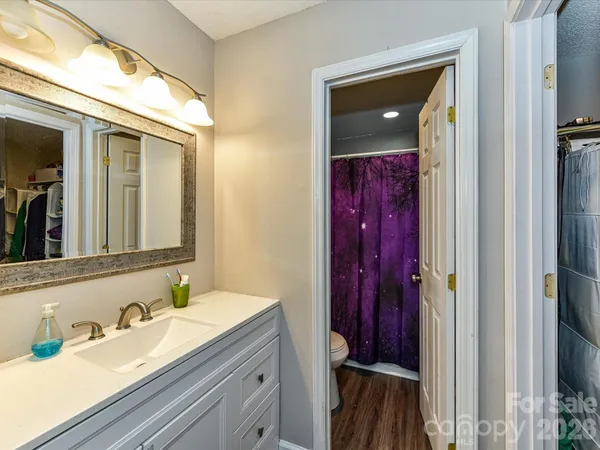 a bathroom with a sink vanity and mirror