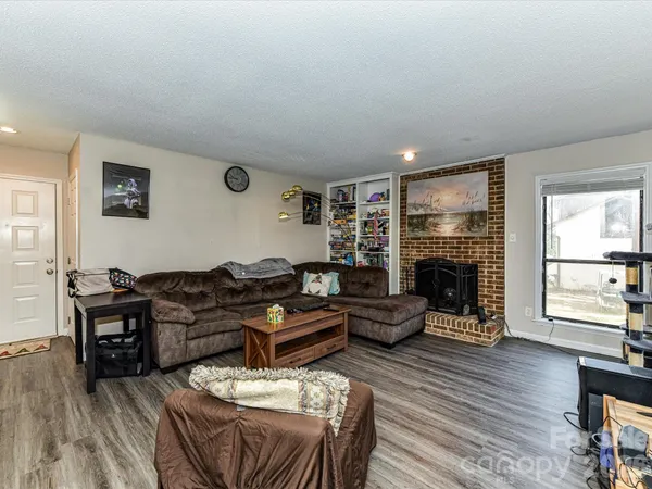 a living room with furniture flat screen tv and a fireplace