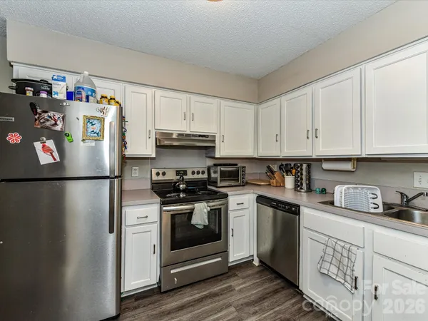 a kitchen with a white cabinets and white appliances