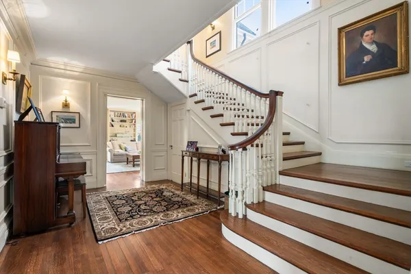 a view of entryway and hall with wooden floor