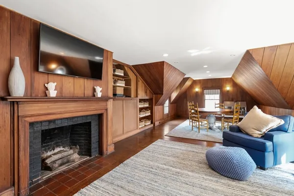 a living room with furniture a flat screen tv and a fireplace