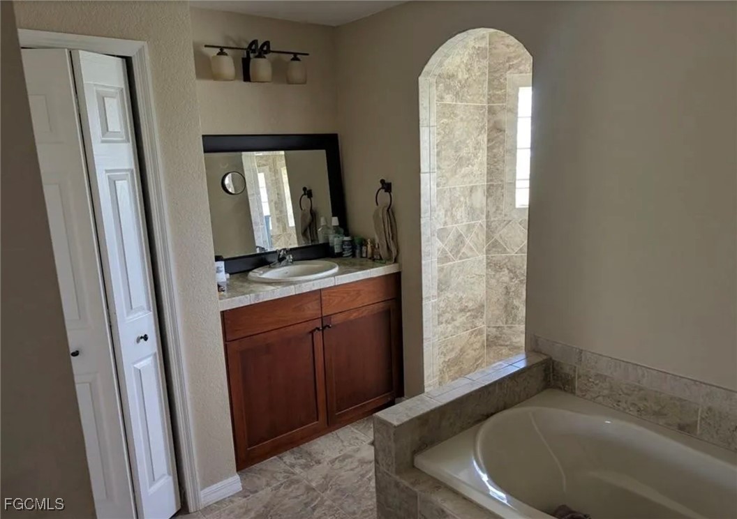 41300 Horseshoe Road Punta Gorda, FL 33982 - Photo 11 of 14 a bathroom with a sink a mirror and shower