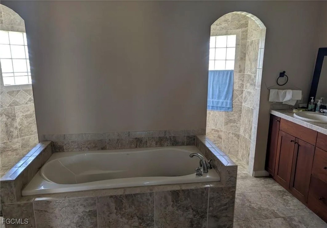 41300 Horseshoe Road Punta Gorda, FL 33982 - Photo 12 of 14 a bath tub sitting in a bathroom next to a window