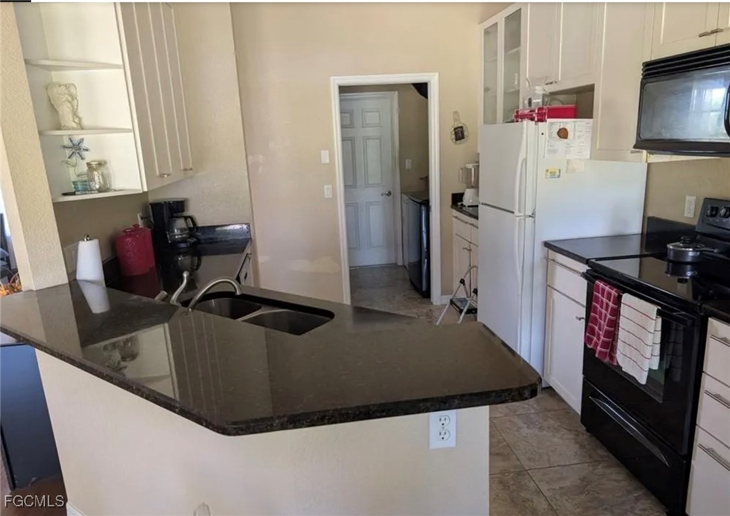 41300 Horseshoe Road Punta Gorda, FL 33982 - Photo 5 of 14 a kitchen with stainless steel appliances granite countertop a sink a refrigerator and a stove