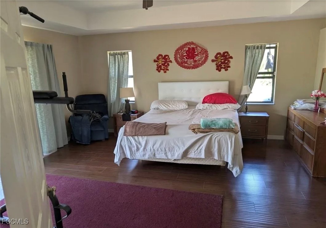 41300 Horseshoe Road Punta Gorda, FL 33982 - Photo 8 of 14 a bedroom with a bed and dresser with wooden floor