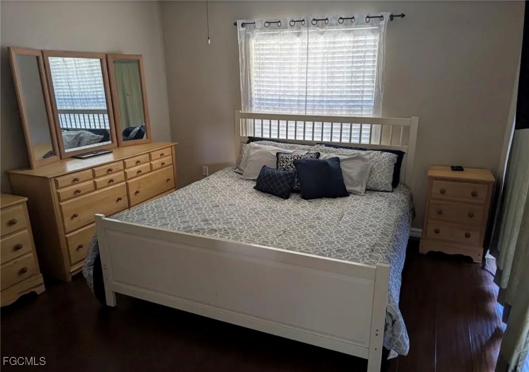 41300 Horseshoe Road Punta Gorda, FL 33982 - Photo 9 of 14 a bedroom with a bed and wooden floor