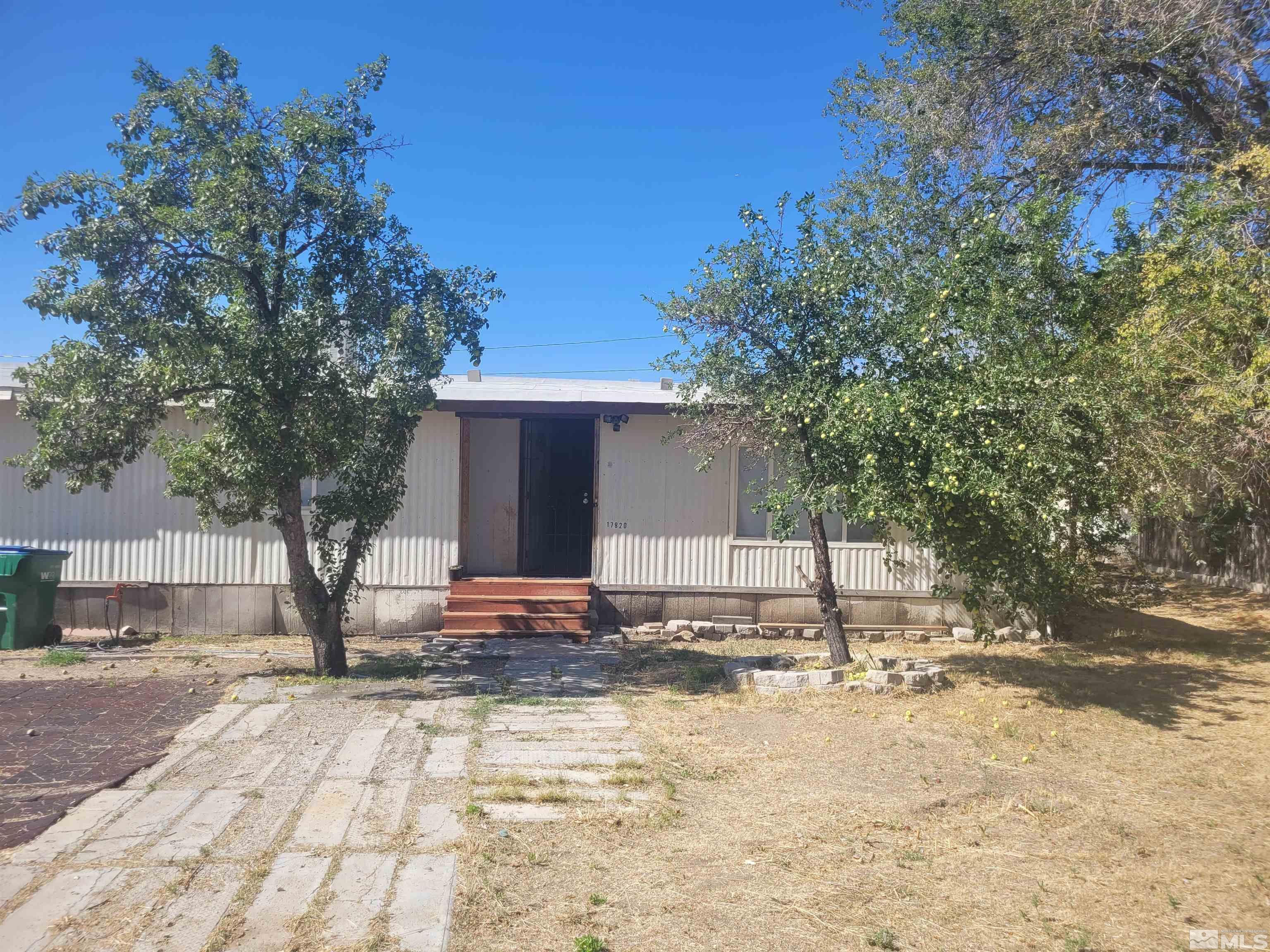 17820 Mockingbird Drive Reno, NV 89508 - Photo 2 of 14 a view of a yard with plants and trees