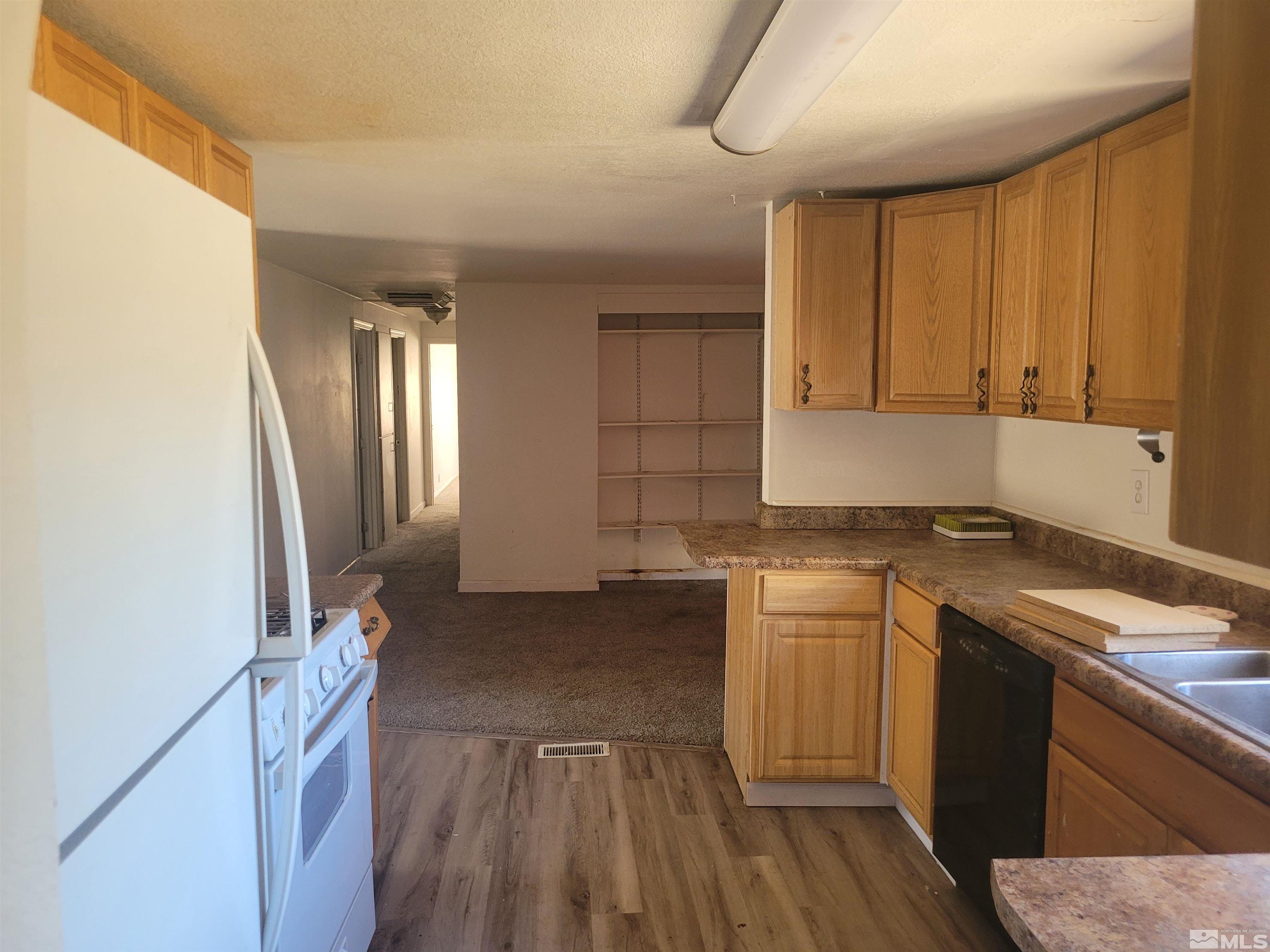 17820 Mockingbird Drive Reno, NV 89508 - Photo 6 of 14 a kitchen with a sink cabinets and wooden floor