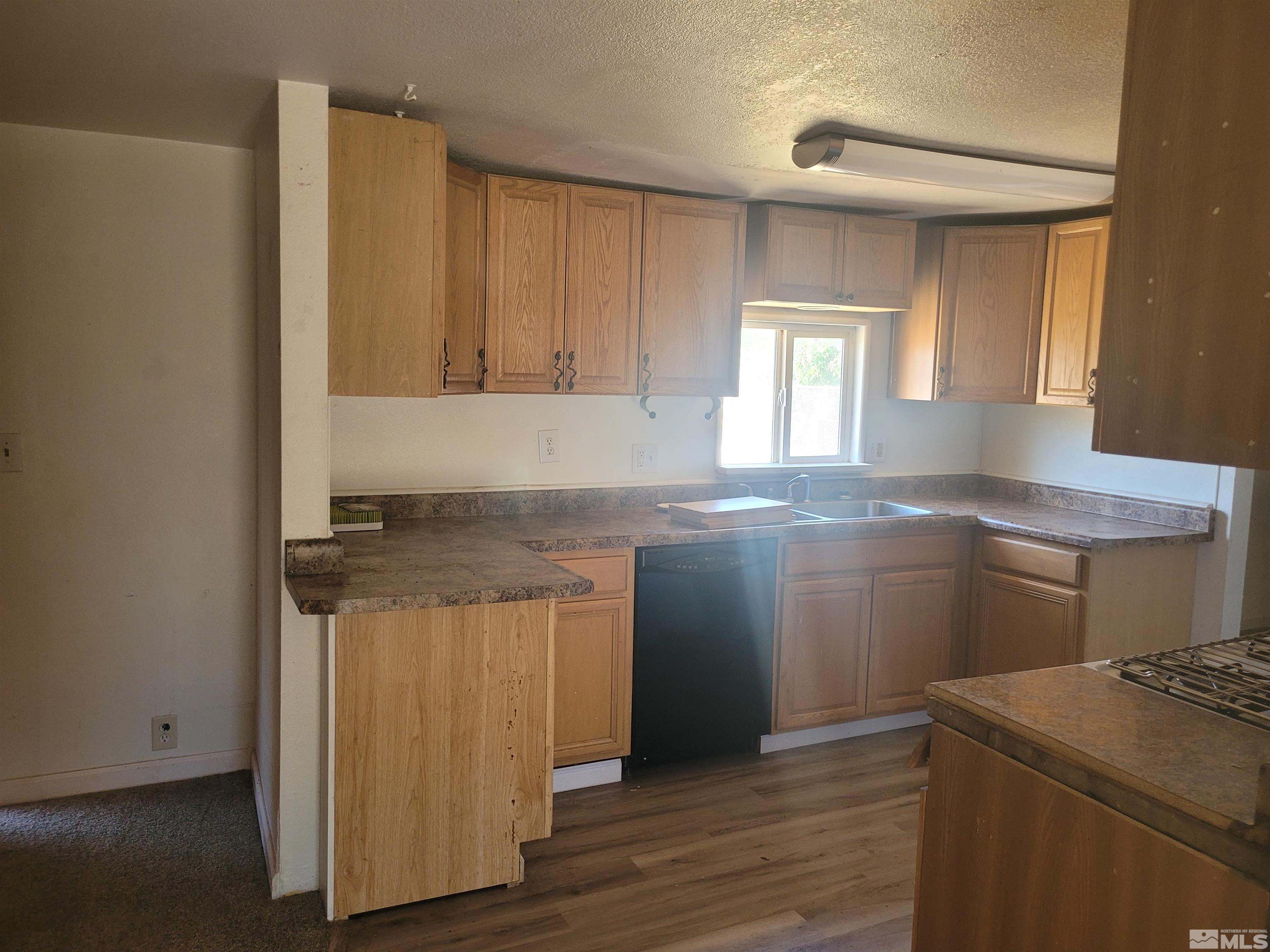17820 Mockingbird Drive Reno, NV 89508 - Photo 7 of 14 a kitchen with stainless steel appliances granite countertop a sink stove and cabinets