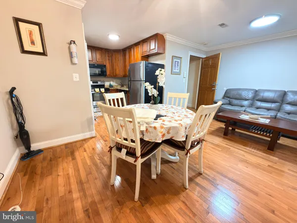 a view of a dining room with furniture and wooden floor
